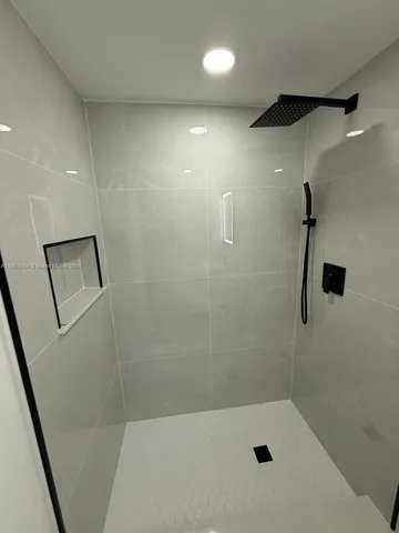a bathroom with a shower and toilet