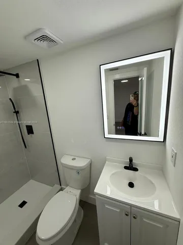 a bathroom with a toilet sink and shower