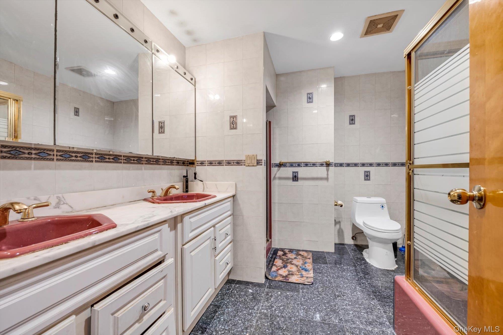 252-71 Brattle Avenue Queens, NY 11362 - Photo 12 of 20 a bathroom with a sink a toilet and a large mirror