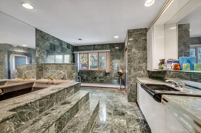 a large white kitchen with sink and refrigerator