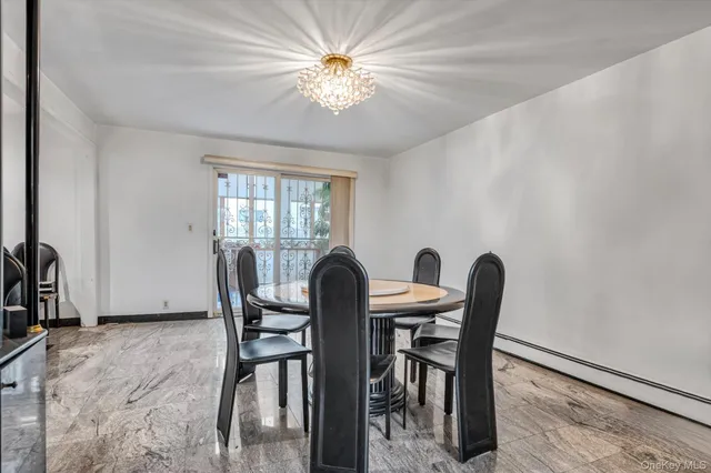 a view of a dining room with furniture and a chandelier