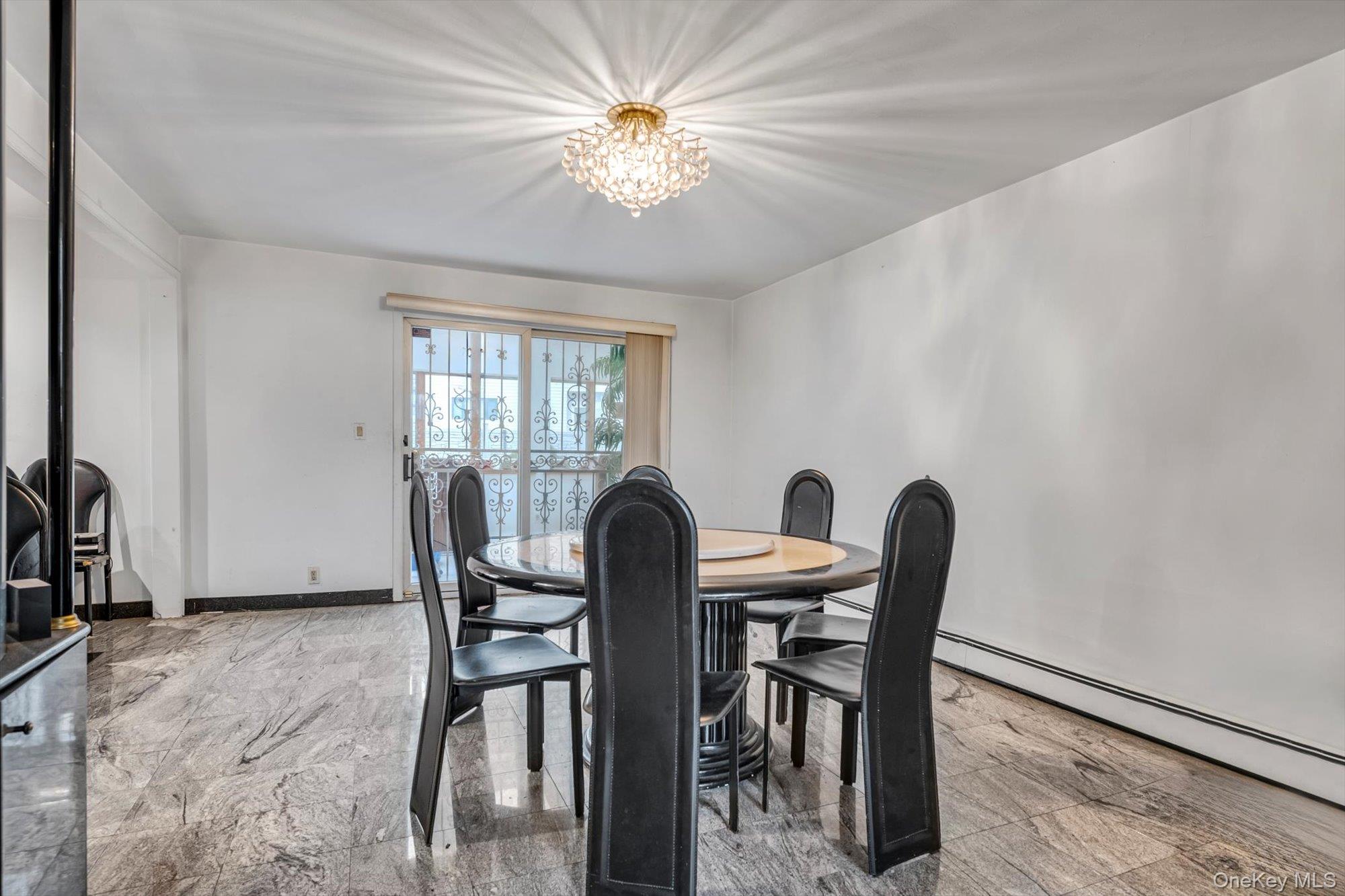 252-71 Brattle Avenue Queens, NY 11362 - Photo 3 of 20 a view of a dining room with furniture and a chandelier
