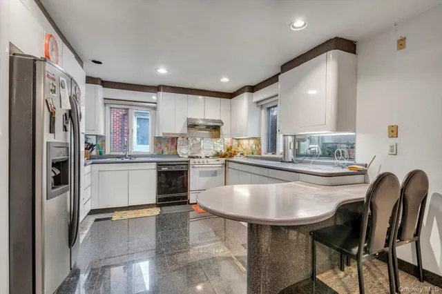 a kitchen with cabinets and stainless steel appliances