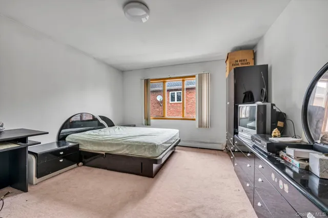 a bedroom with bed and window