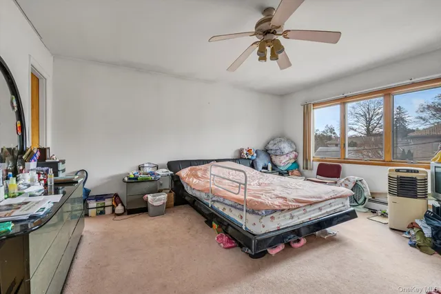 a bed sitting in a room next to a window