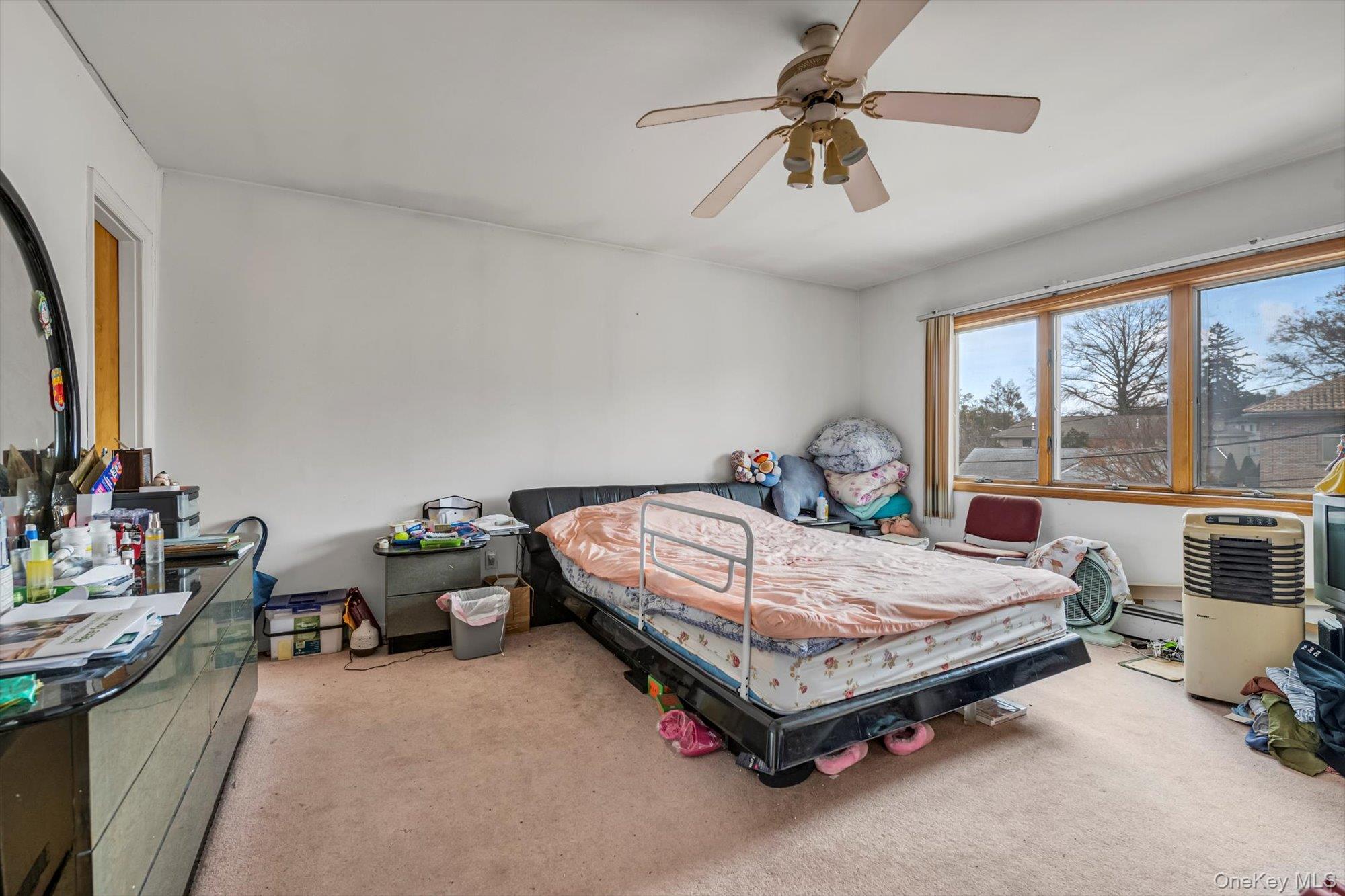 252-71 Brattle Avenue Queens, NY 11362 - Photo 10 of 20 a bed sitting in a room next to a window