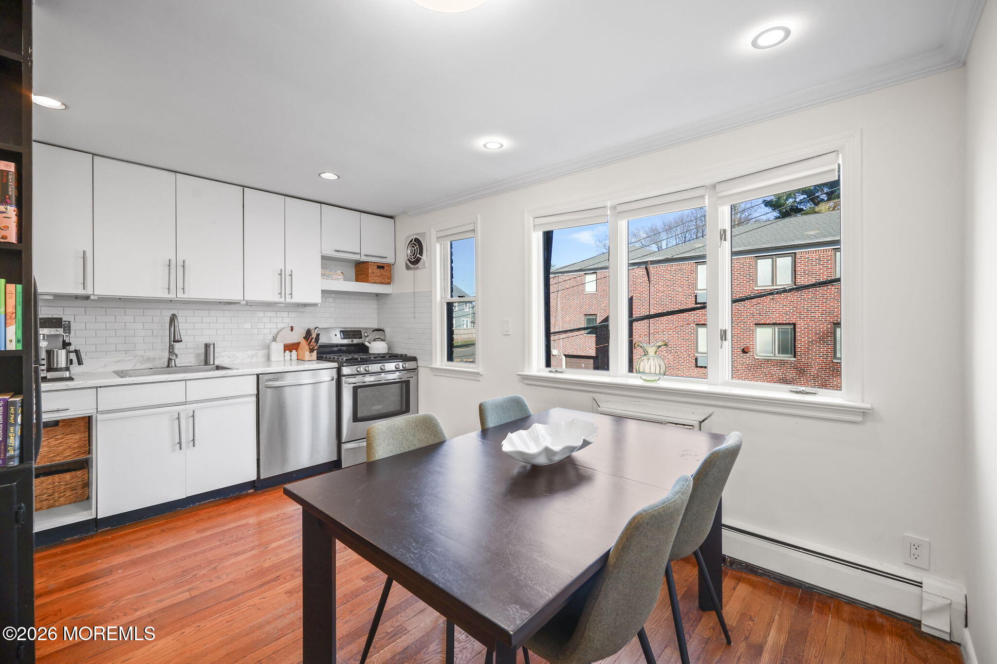 39 Manor Drive Red Bank, NJ 07701 - Photo 8 of 19 a open dining room with stainless steel appliances kitchen island granite countertop a stove a sink a dining table and chairs