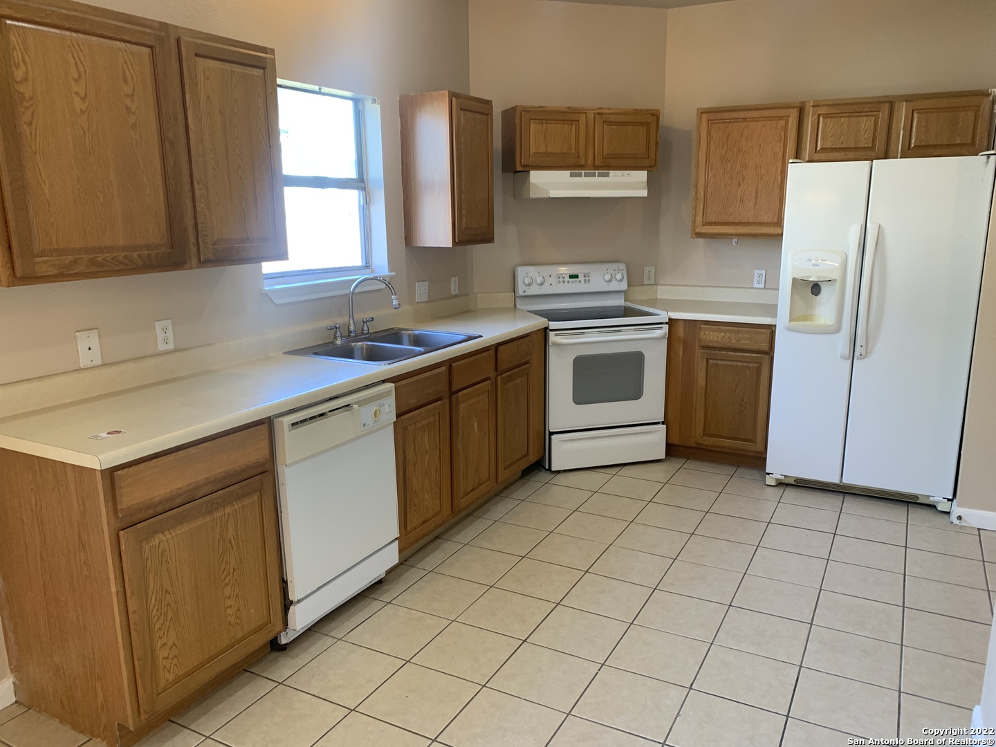 6911 Hallie Ridge San Antonio, TX 78227 - Photo 5 of 22 a kitchen with a stove sink and cabinets
