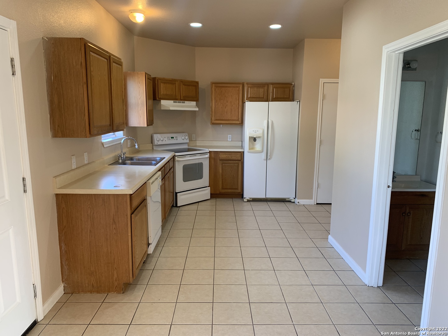 6911 Hallie Ridge San Antonio, TX 78227 - Photo 6 of 22 a kitchen with a sink a counter top space cabinets and stainless steel appliances