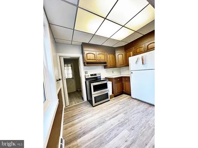 a kitchen with stainless steel appliances a refrigerator and a stove top oven