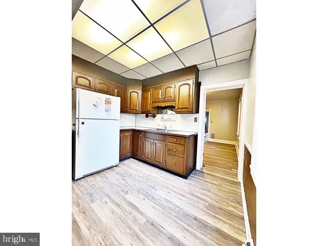 a kitchen with a stove a refrigerator and a sink