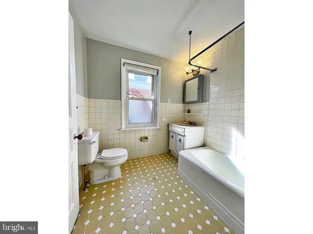 a bathroom with a toilet sink and shower