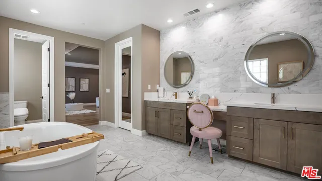 a bathroom with a sink a mirror a vanity and shower