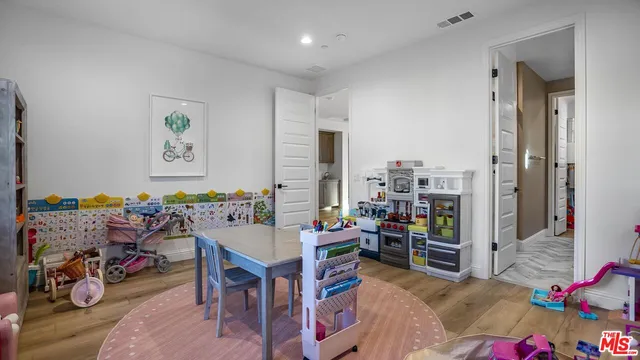 a front view of a house with garden and plants