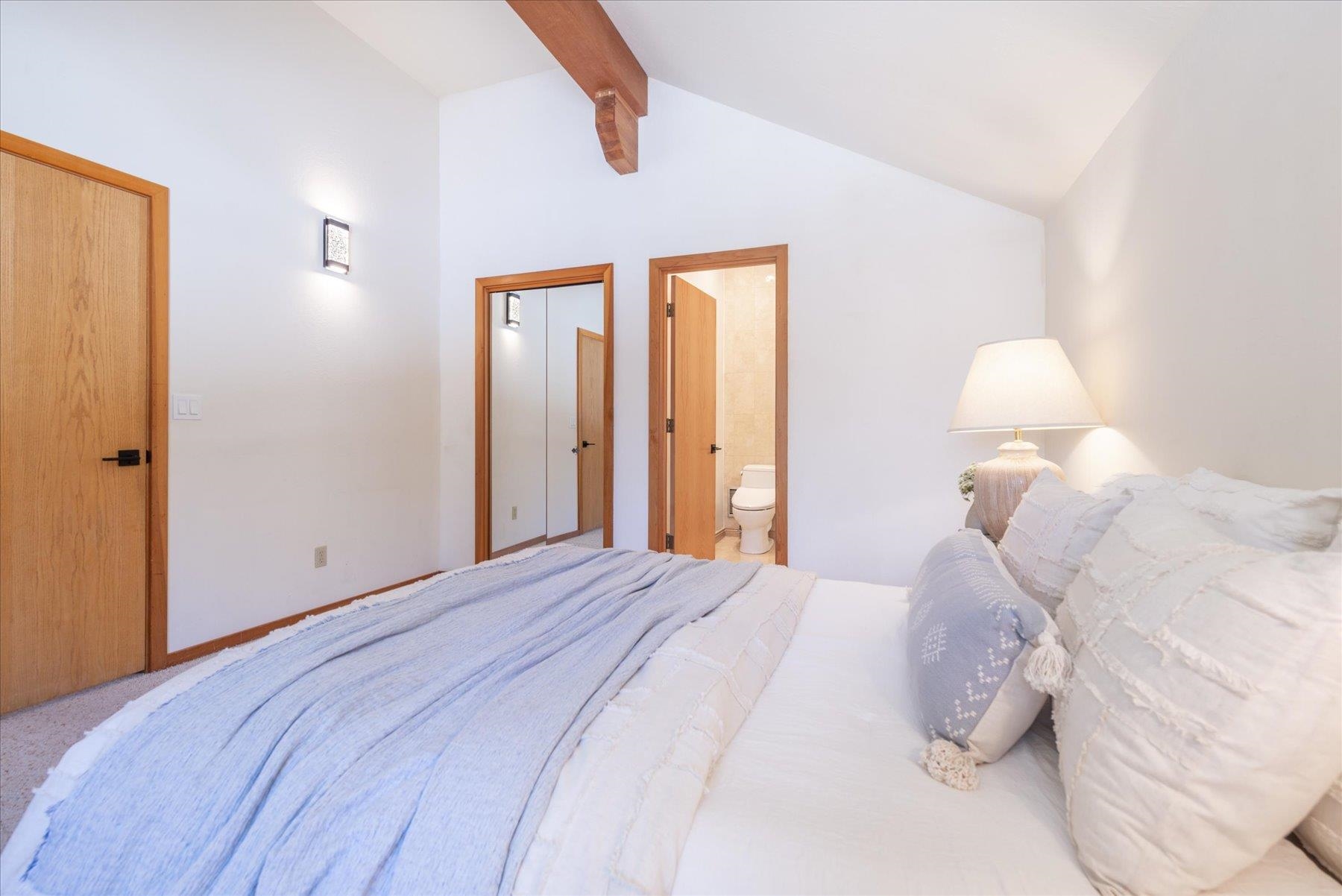 265 Basque Drive Truckee, CA 96161 - Photo 14 of 25 a bedroom with a bed and a chandelier