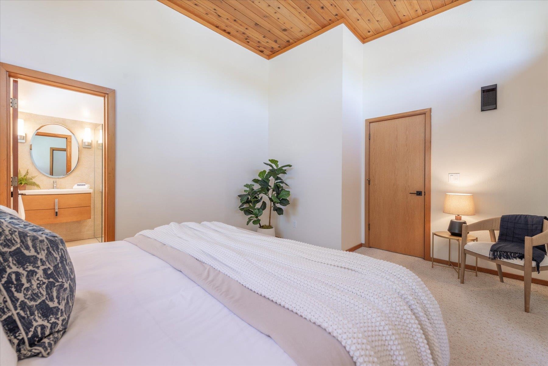 265 Basque Drive Truckee, CA 96161 - Photo 17 of 25 a bedroom with a bed and chair