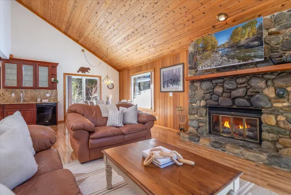 a living room with furniture a fireplace and a large window