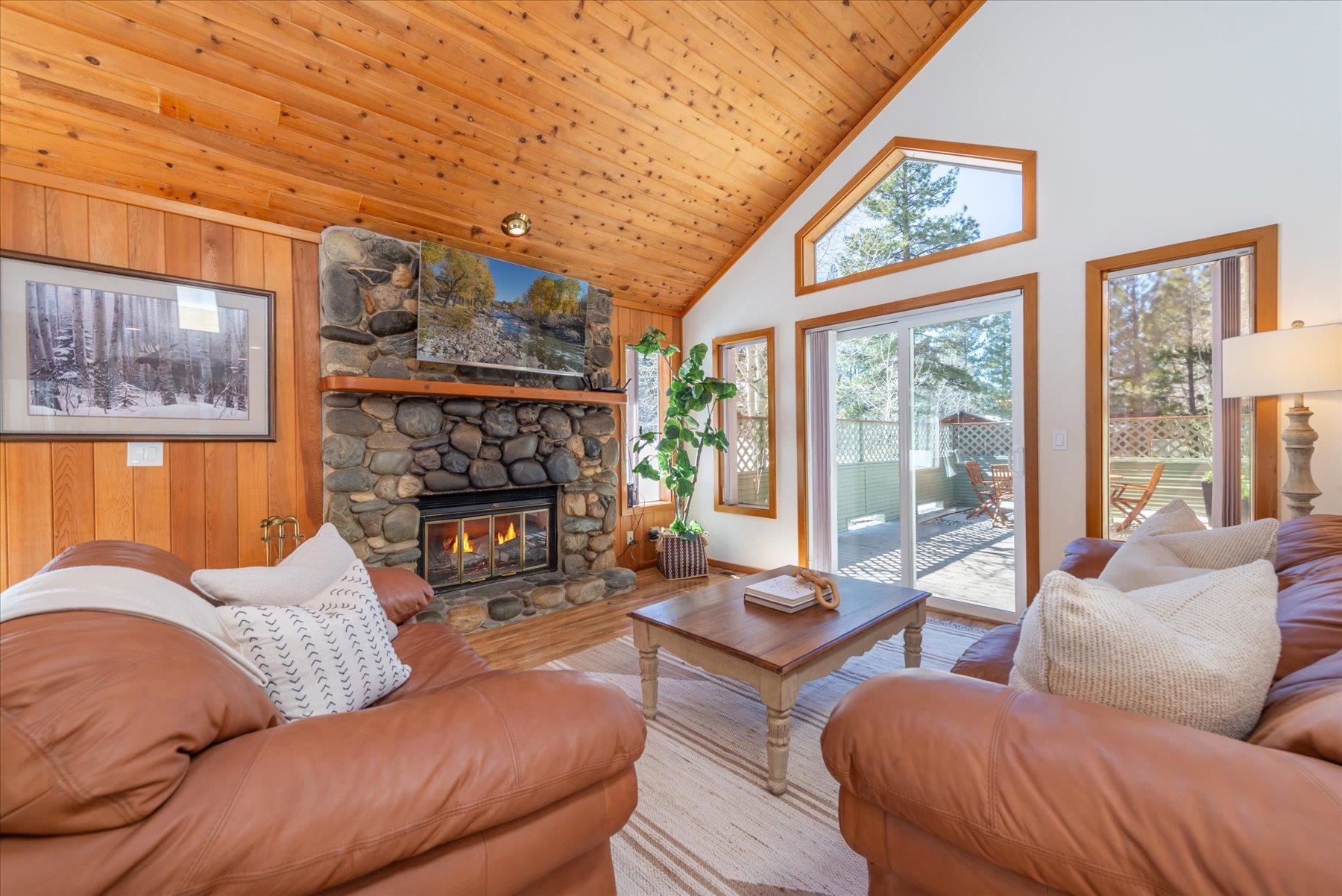 265 Basque Drive Truckee, CA 96161 - Photo 5 of 25 a living room with furniture a fireplace and a large window