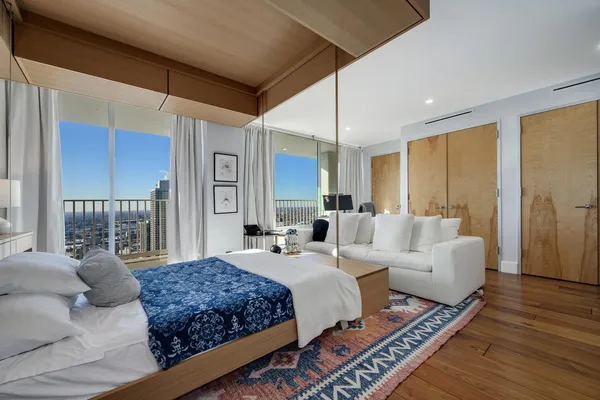 a spacious bedroom with a large bed and a couch