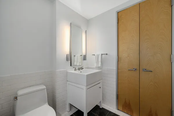 a bathroom with a sink toilet and vanity