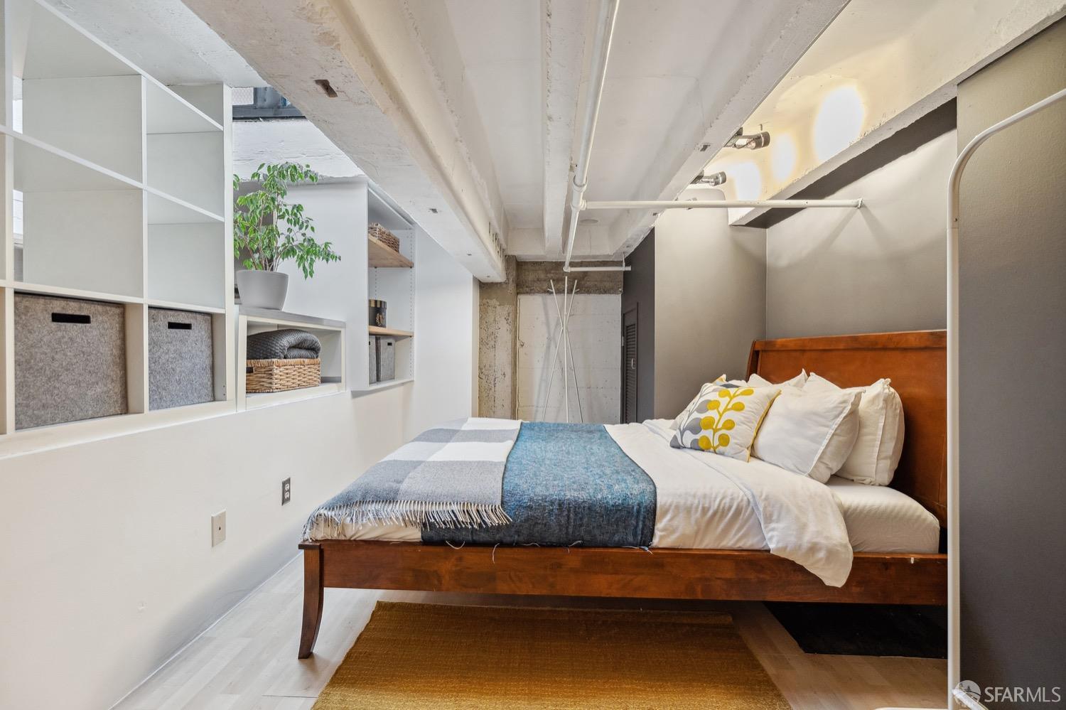 247 4th Street, Unit 406 Oakland, CA 94607 - Photo 12 of 46 a bedroom with a bed and wooden floor