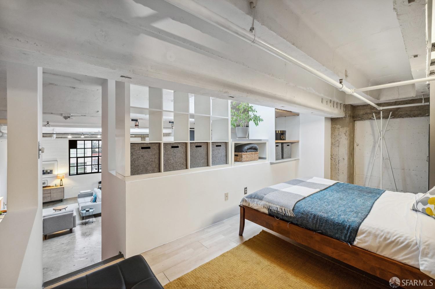 247 4th Street, Unit 406 Oakland, CA 94607 - Photo 14 of 46 a bedroom with a large bed and a view of kitchen