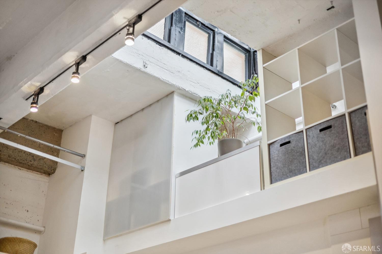 247 4th Street, Unit 406 Oakland, CA 94607 - Photo 15 of 46 a view of staircase with wooden floor and a potted plant