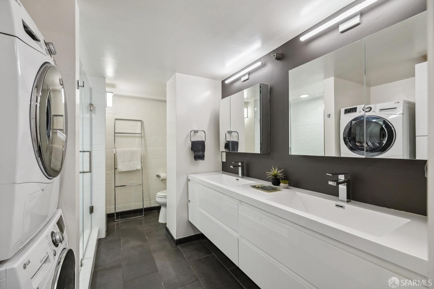 247 4th Street, Unit 406 Oakland, CA 94607 - Photo 16 of 46 a bathroom with a sink a mirror and a shower