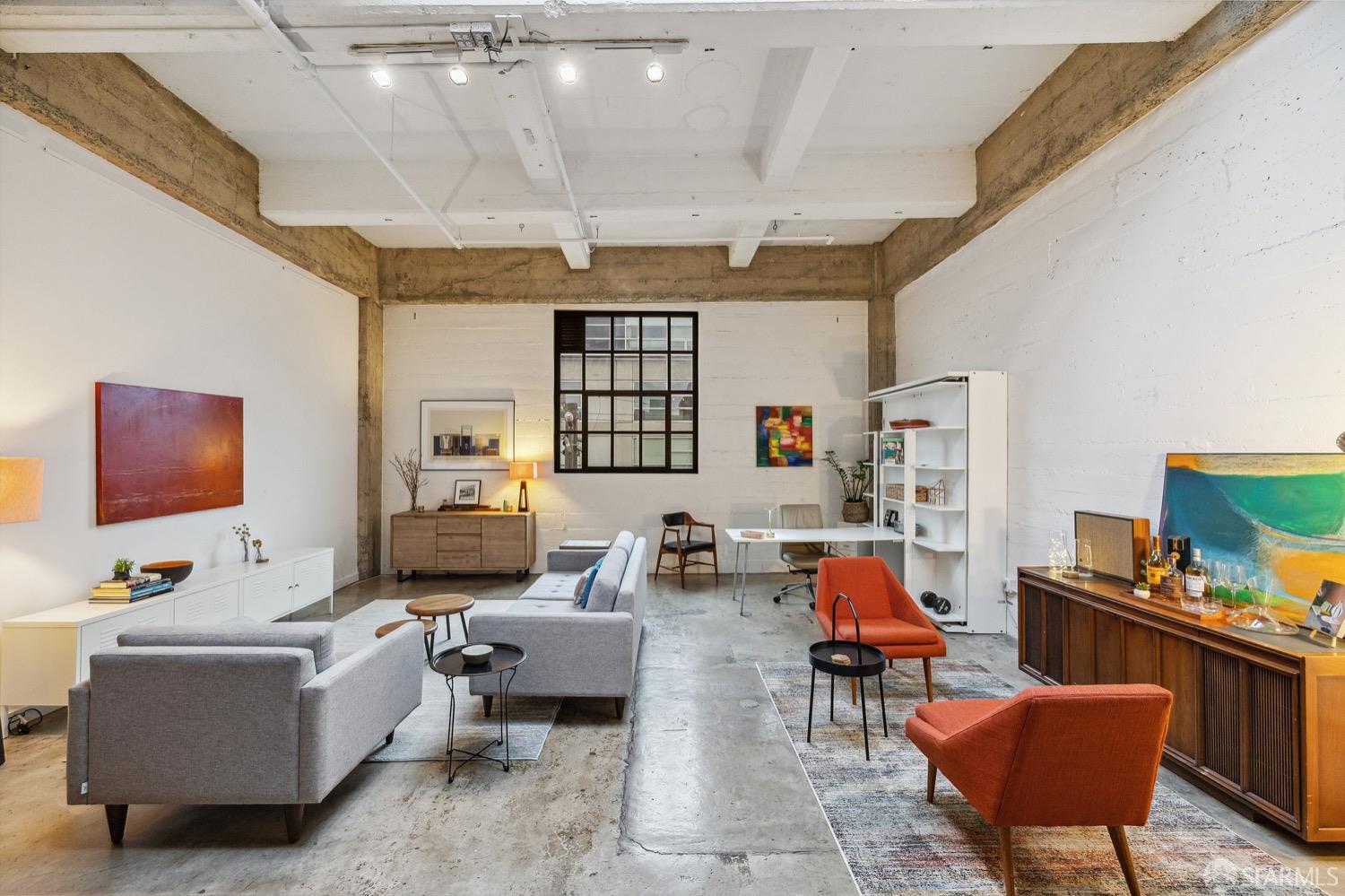 247 4th Street, Unit 406 Oakland, CA 94607 - Photo 2 of 46 a living room with furniture and a flat screen tv