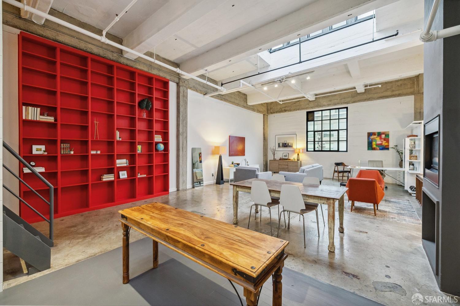 247 4th Street, Unit 406 Oakland, CA 94607 - Photo 21 of 46 a living room with furniture a rug and a bookshelf