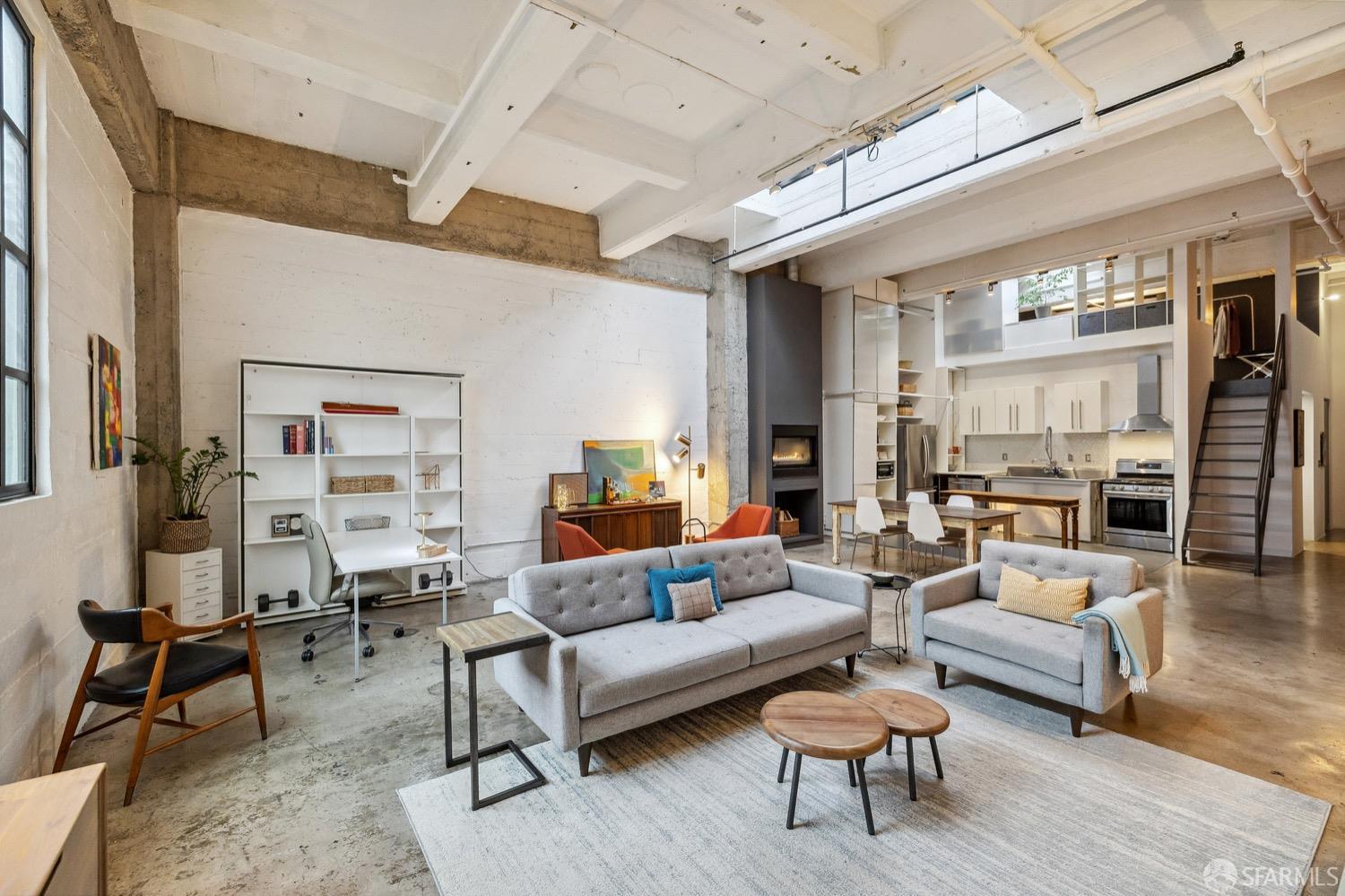 247 4th Street, Unit 406 Oakland, CA 94607 - Photo 37 of 46 a living room with furniture and a painting on the wall