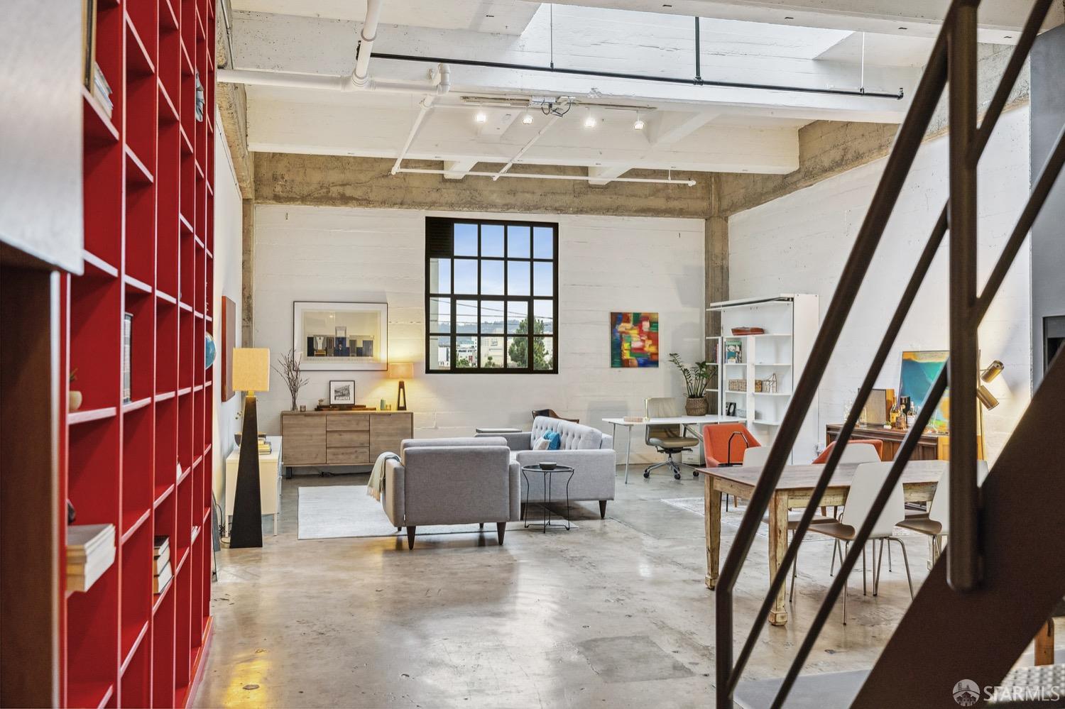 247 4th Street, Unit 406 Oakland, CA 94607 - Photo 5 of 46 a living room with furniture and a window