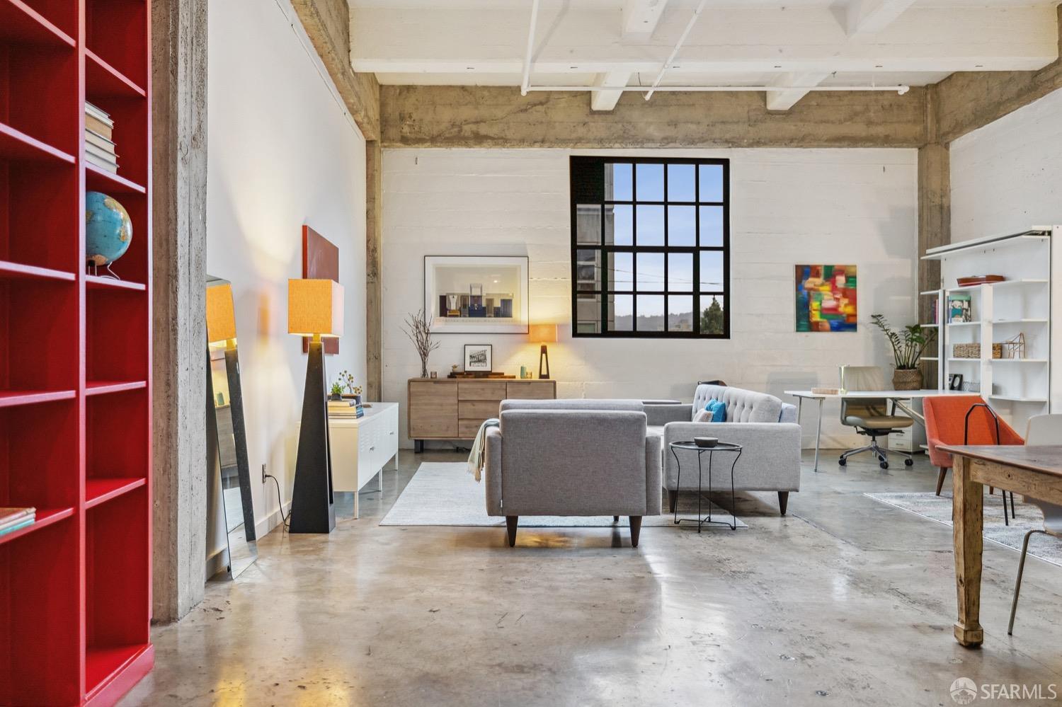 247 4th Street, Unit 406 Oakland, CA 94607 - Photo 6 of 46 a living room with furniture a window and a wooden floor
