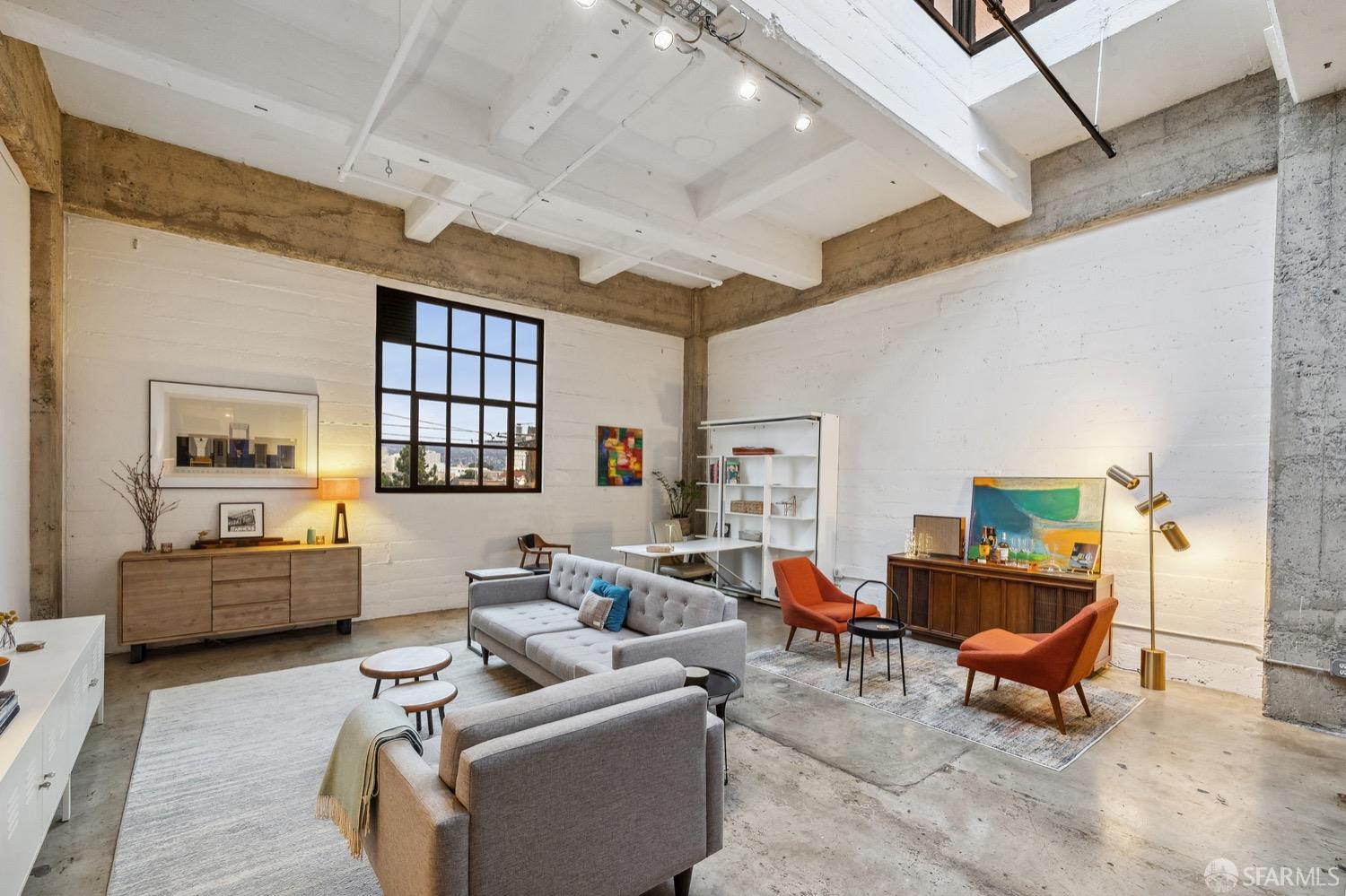 247 4th Street, Unit 406 Oakland, CA 94607 - Photo 7 of 46 a living room with furniture and a window
