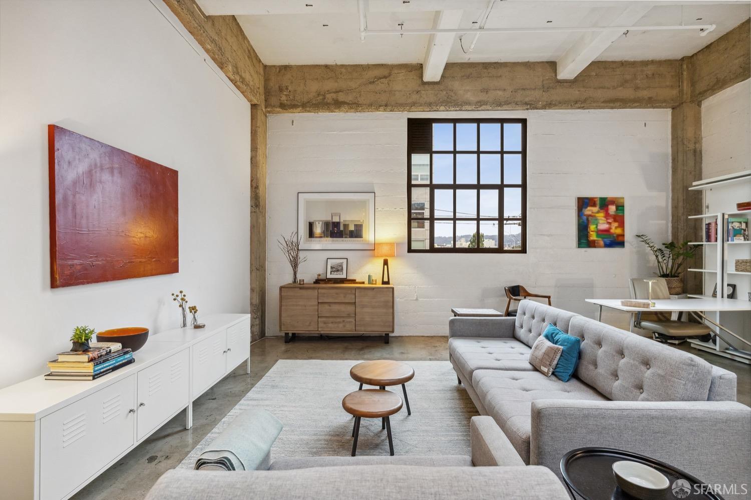 247 4th Street, Unit 406 Oakland, CA 94607 - Photo 10 of 46 a living room with furniture and a flat screen tv