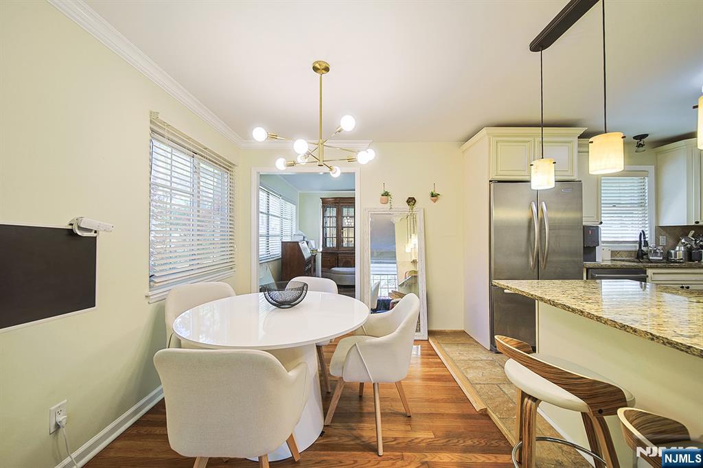 181 Crescent Street Closter, NJ 07624 - Photo 12 of 25 a kitchen with sink refrigerator dining table and chairs
