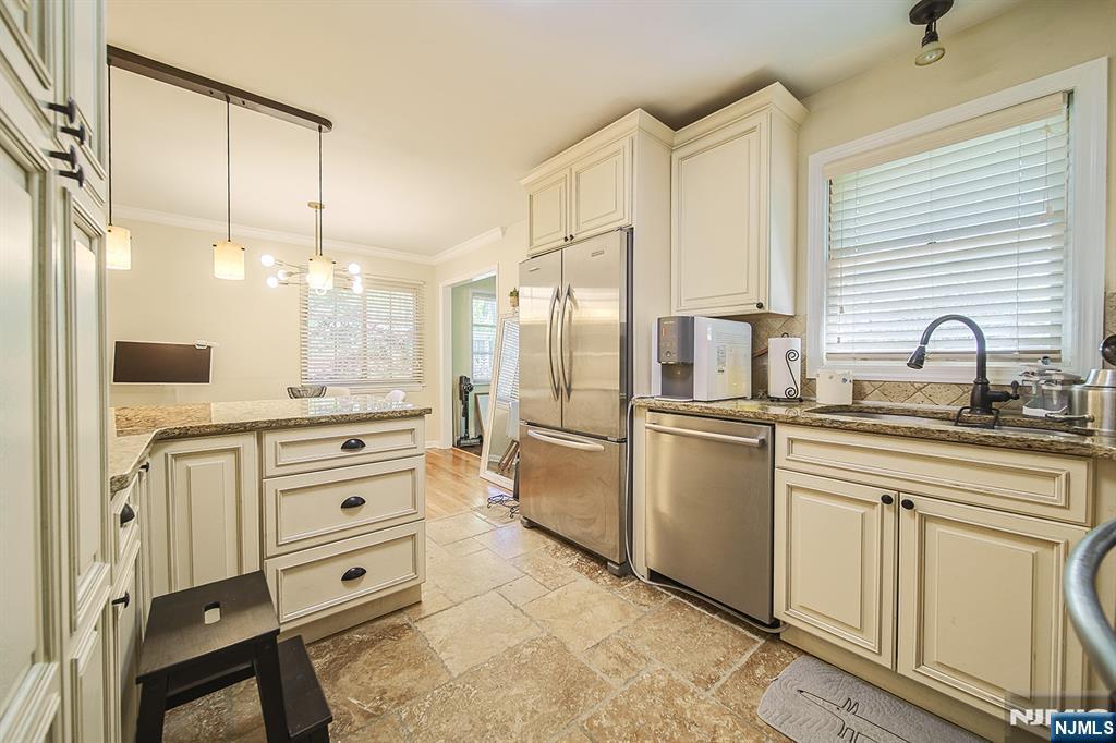 181 Crescent Street Closter, NJ 07624 - Photo 15 of 25 a kitchen with white cabinets and refrigerator