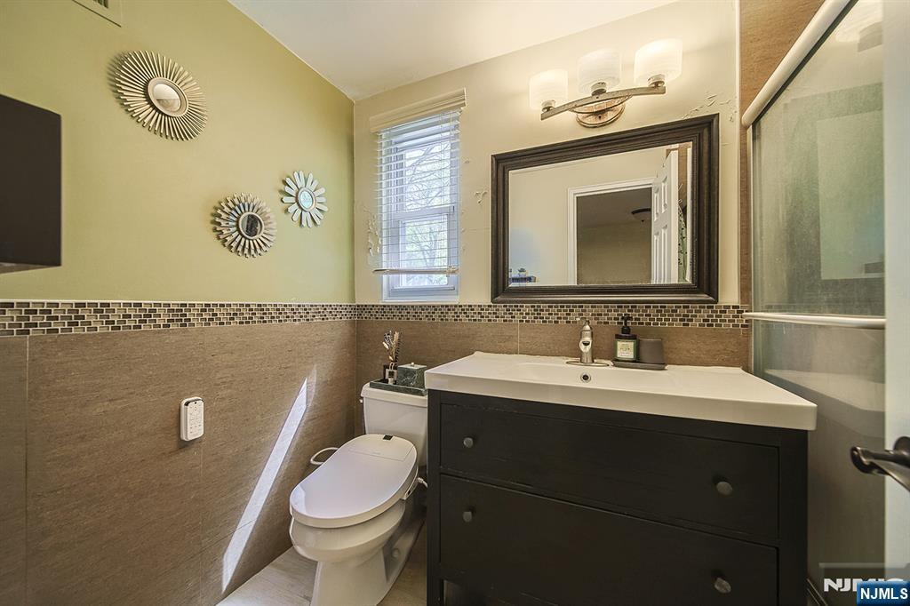 181 Crescent Street Closter, NJ 07624 - Photo 24 of 25 a bathroom with a toilet sink and mirror