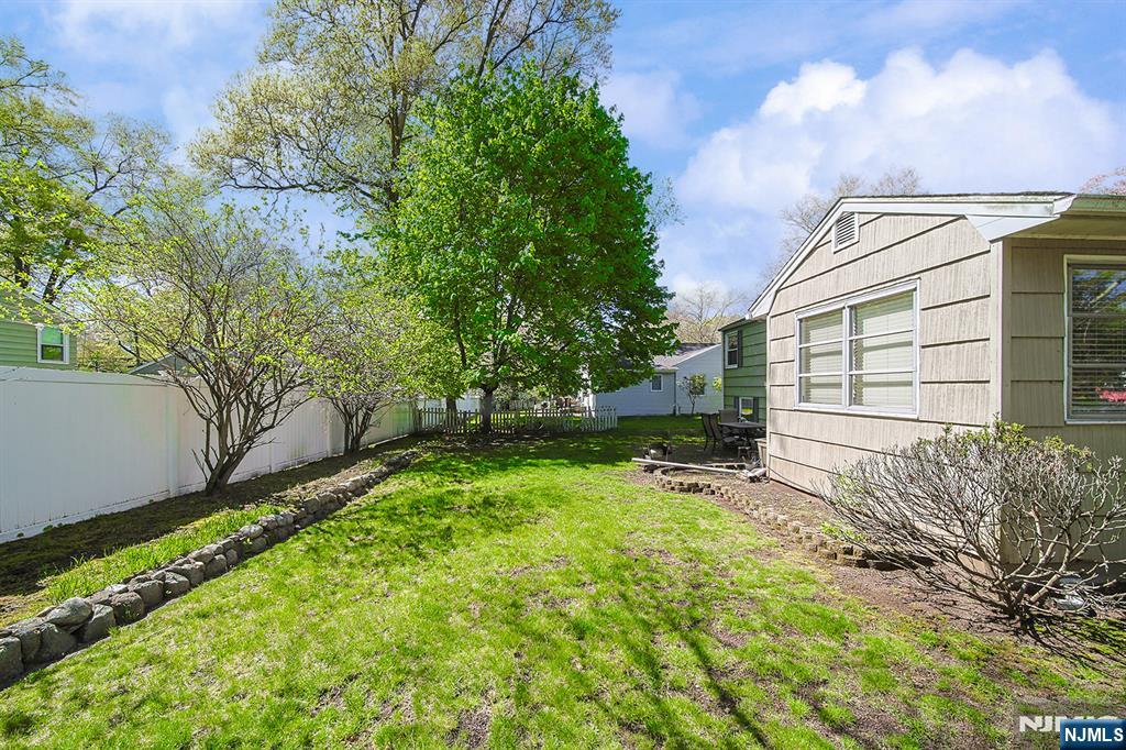181 Crescent Street Closter, NJ 07624 - Photo 3 of 25 a view of backyard with a garden and trees