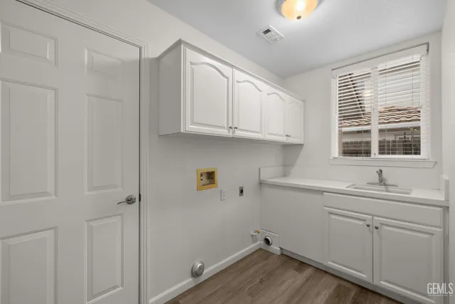 a view of cabinets a sink and dishwasher in a kitchen
