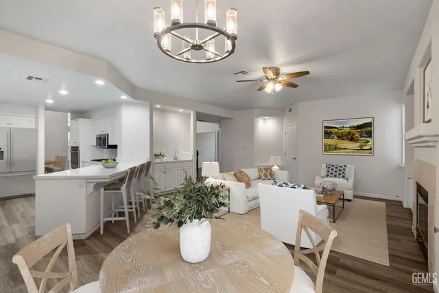 a view of a dining room with furniture a chandelier and wooden floor