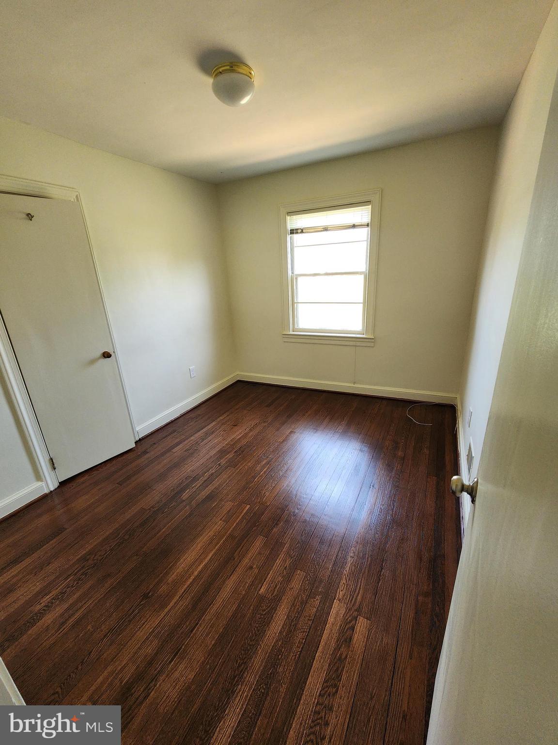 7465 Oakland Mills Road Columbia, MD 21046 - Photo 11 of 23 an empty room with wooden floor and windows
