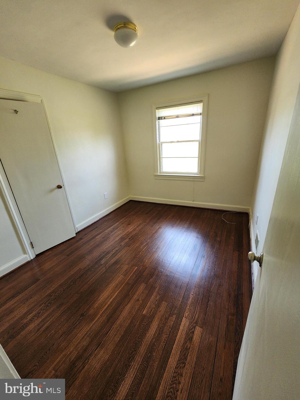 7465 Oakland Mills Road Columbia, MD 21046 - Photo 12 of 23 an empty room with wooden floor and windows
