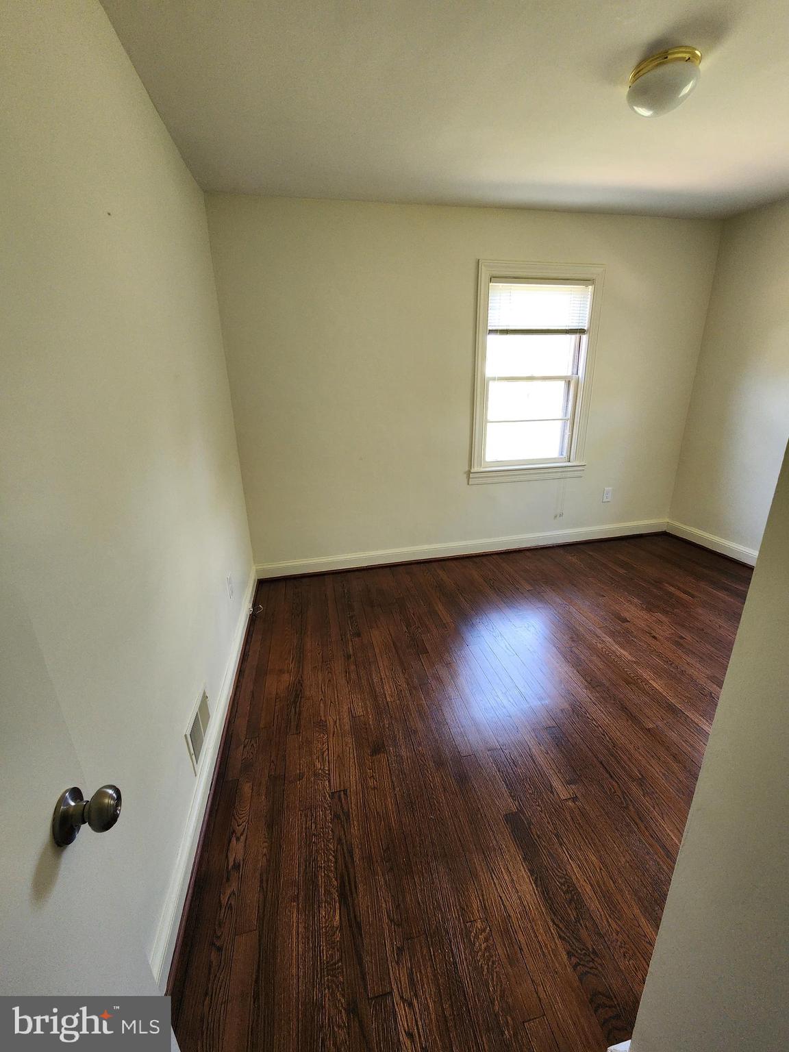 7465 Oakland Mills Road Columbia, MD 21046 - Photo 13 of 23 an empty room with wooden floor and windows