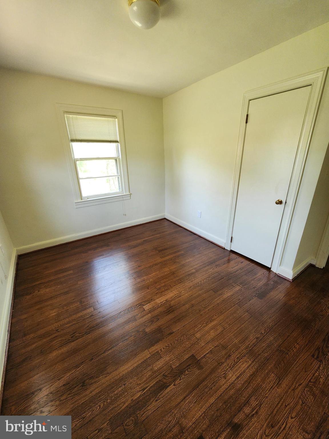 7465 Oakland Mills Road Columbia, MD 21046 - Photo 14 of 23 an empty room with wooden floor and windows