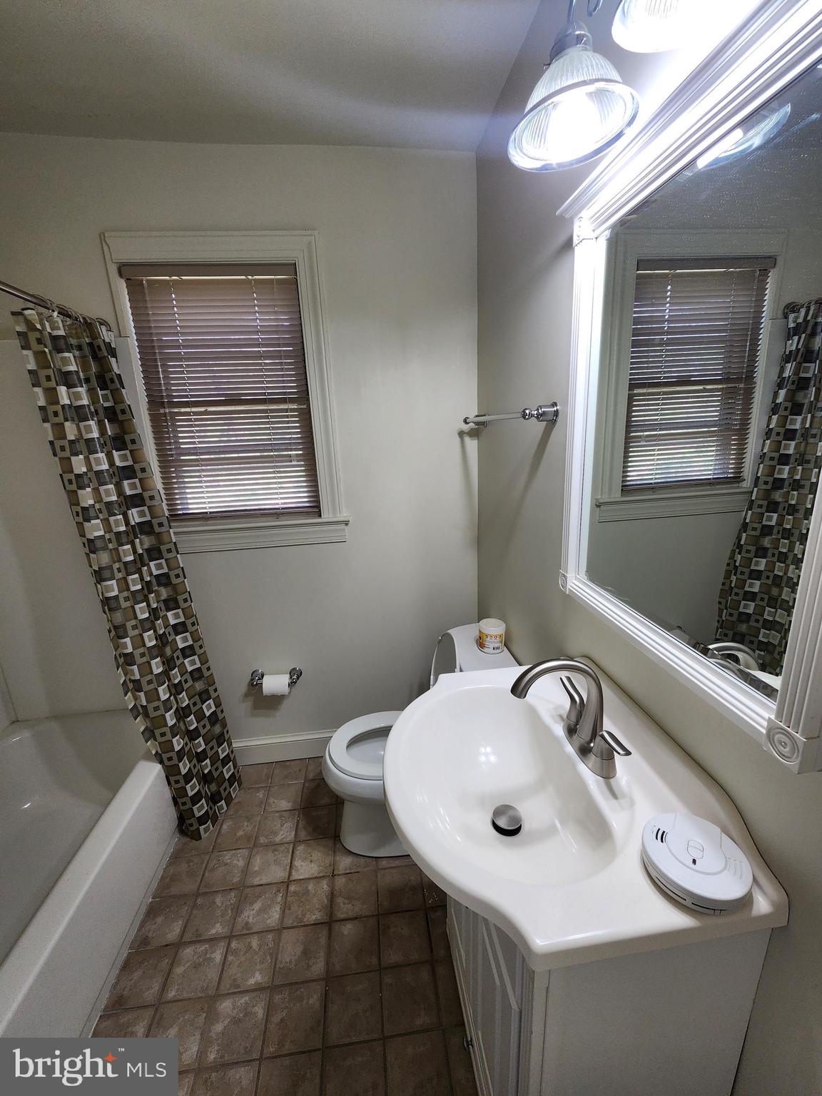 7465 Oakland Mills Road Columbia, MD 21046 - Photo 15 of 23 a bathroom with a sink a toilet and shower