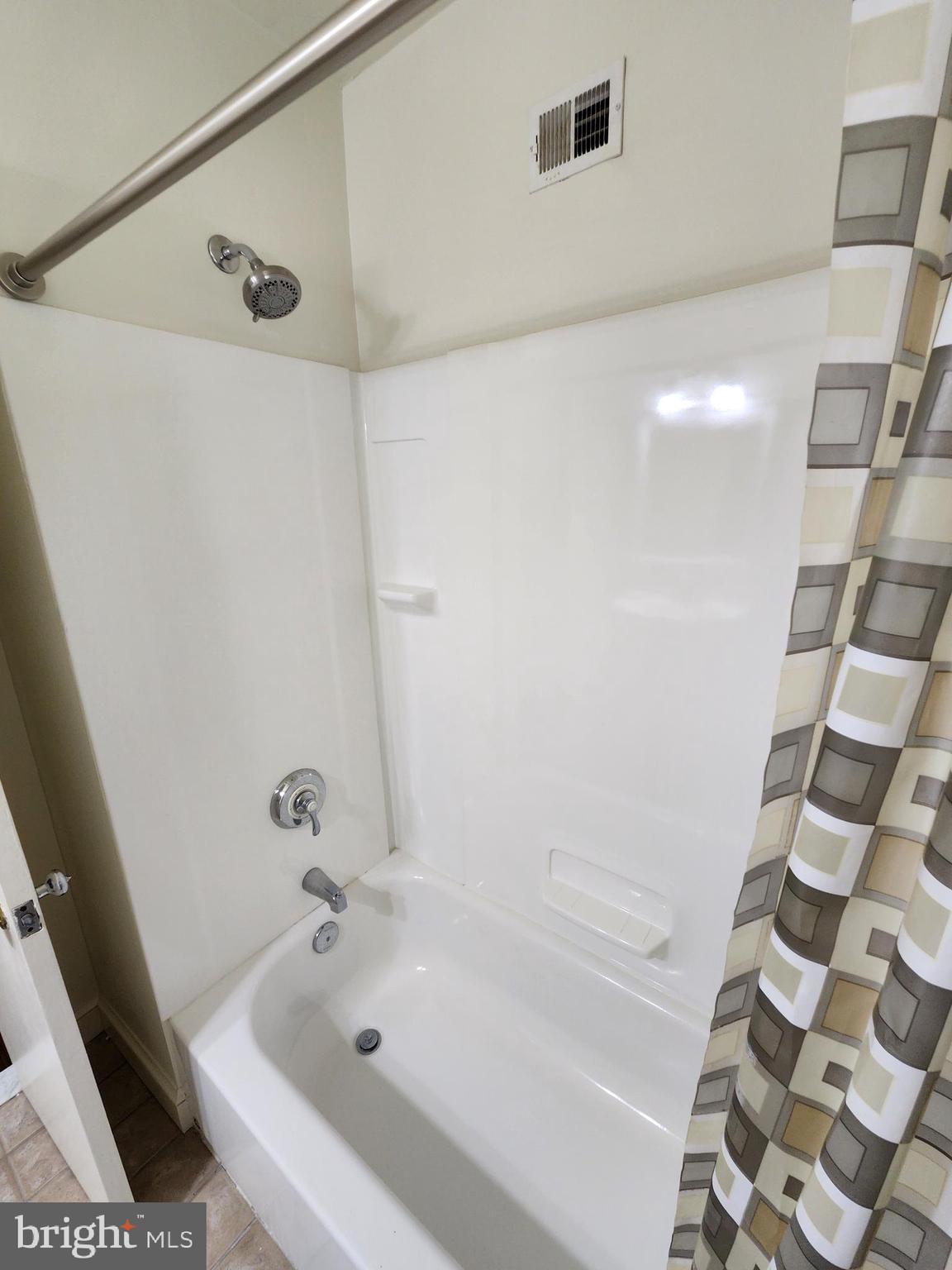 7465 Oakland Mills Road Columbia, MD 21046 - Photo 16 of 23 a bathroom with a bathtub and a shower