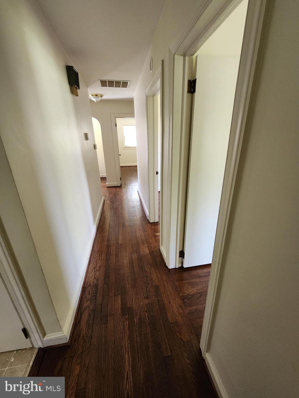 7465 Oakland Mills Road Columbia, MD 21046 - Photo 17 of 23 a view of a hallway with wooden floor and staircase