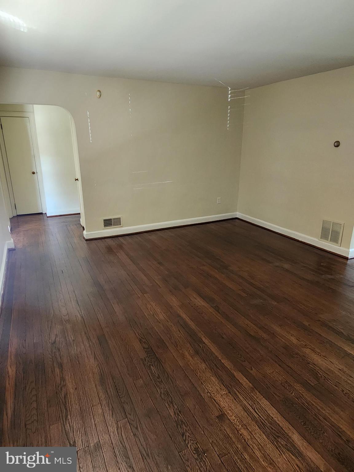 7465 Oakland Mills Road Columbia, MD 21046 - Photo 3 of 23 a view of an empty room with wooden floor