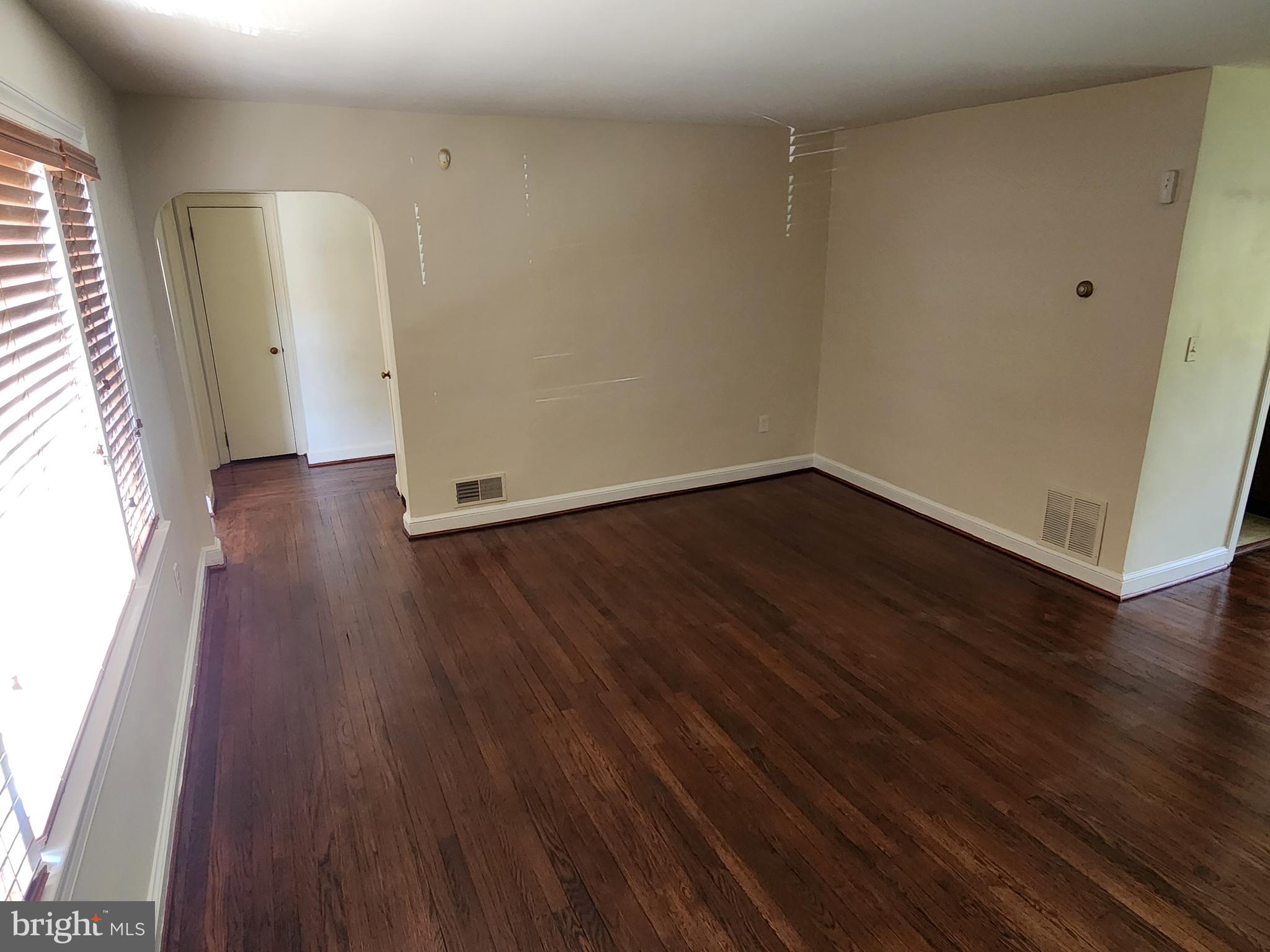 7465 Oakland Mills Road Columbia, MD 21046 - Photo 4 of 23 an empty room with wooden floor and windows